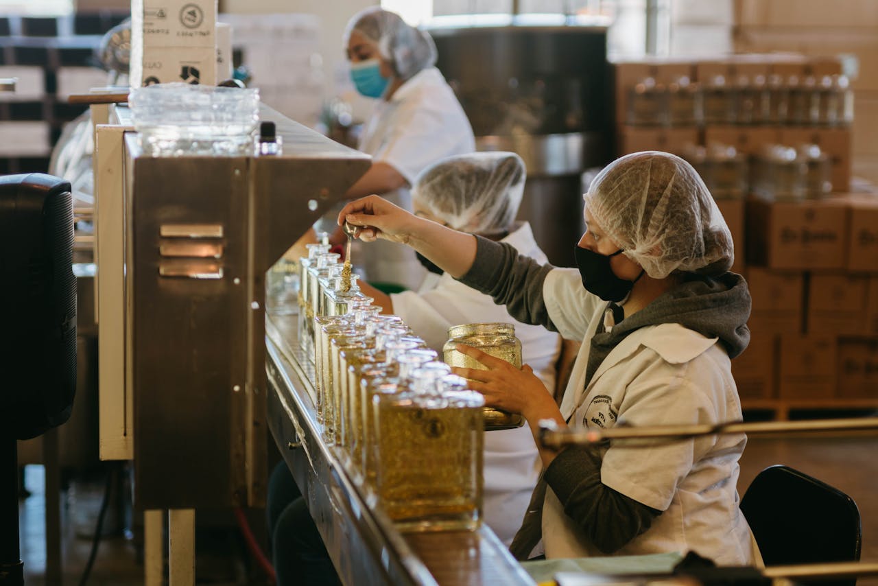 who-we-are Women workers process tequila bottles on a production line inside a Mexican distillery.