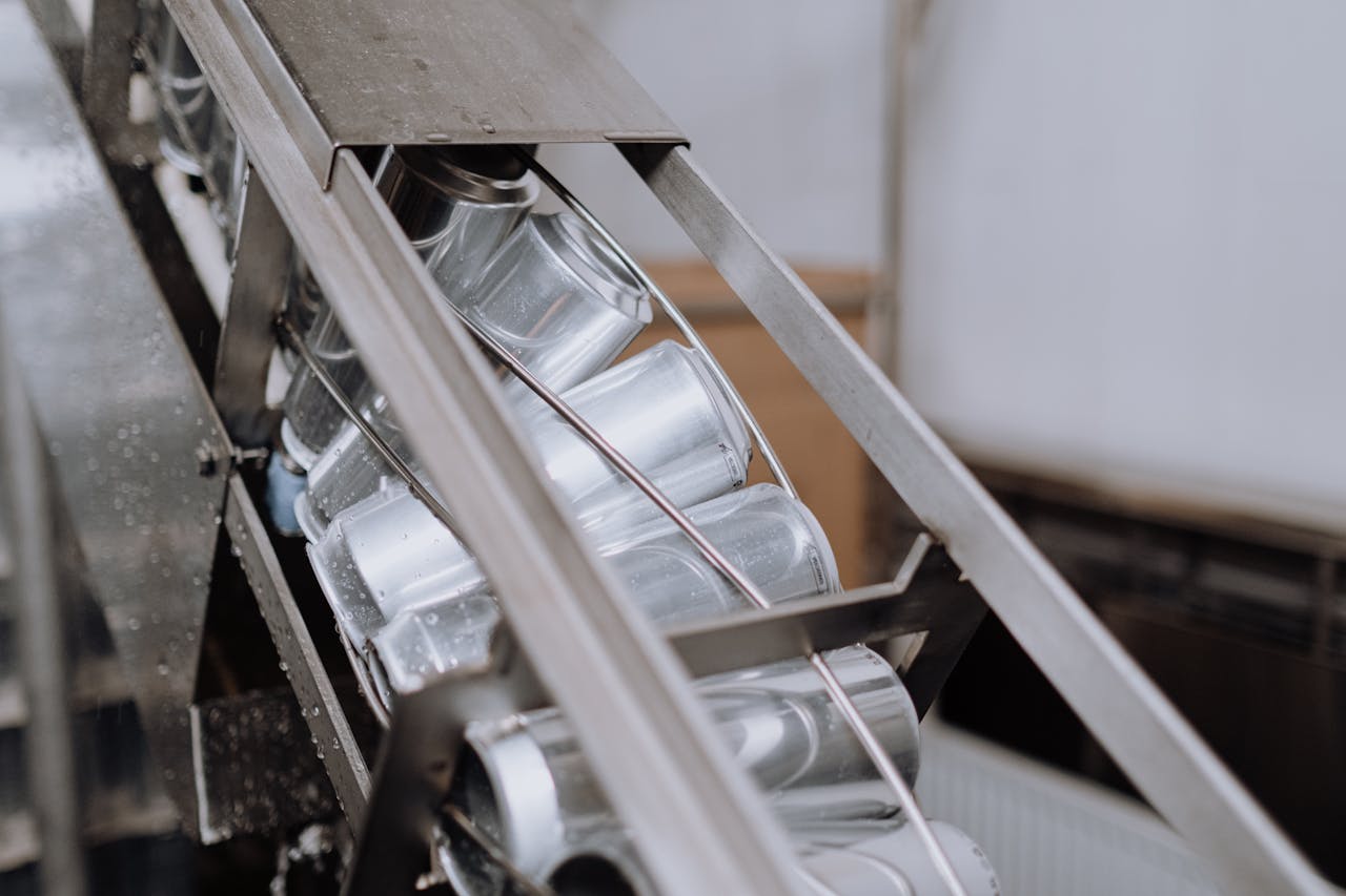 Close-up of automated canning equipment in a brewery showcasing production efficiency.